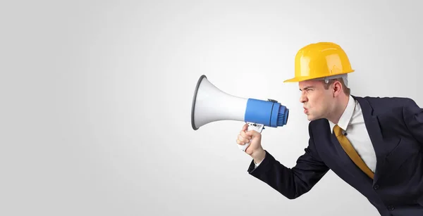 Young architect yelling with megaphone — Stock Photo, Image