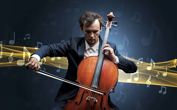 Musicien jouant sur violoncelle avec des notes autour — Photo