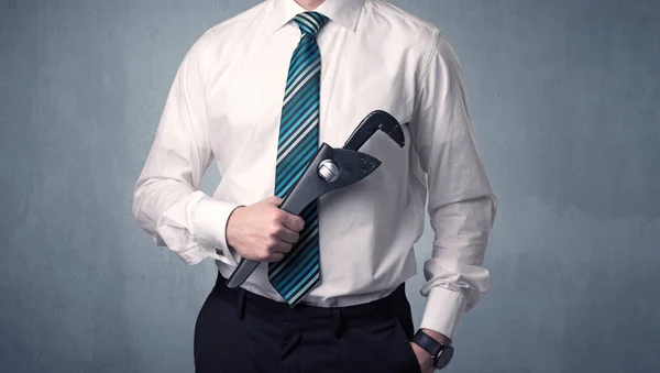 Businesman standing with tool on his hand — Stock Photo, Image