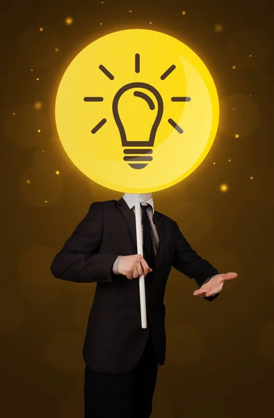 Businessman holding lightbulb sign — Stock Photo, Image