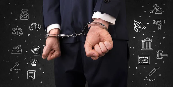 Symbols of courthouse with handcuffed man — Stock Photo, Image