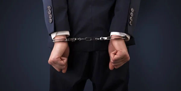 Dark backgrounded close handcuffed man — Stock Photo, Image