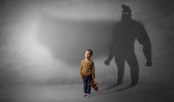 Cute kid with hero shadow behind — Stock Photo, Image