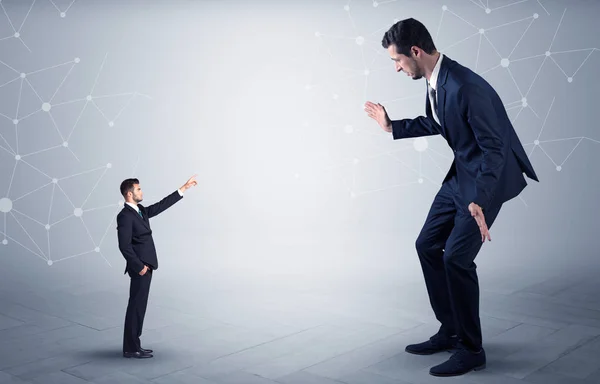 Small man aiming at a big man with network concept — Stock Photo, Image