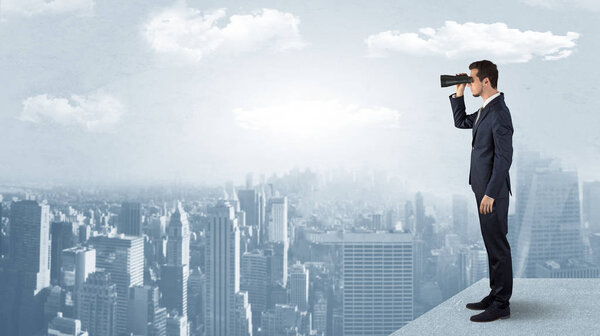 Man looking forward from the top of a skyscraper
