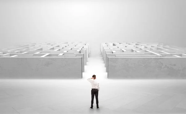 Businessman going straight ahead between two mazes