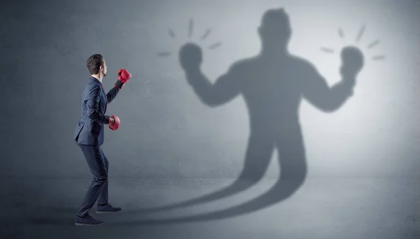 Businessman fighting with his unarmed shadow — Stock Photo, Image