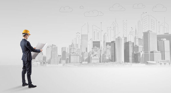 Architect standing and  replanning a city panorama