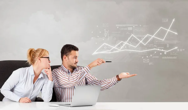 Business person sitting at desk with financial change concept — Stock Photo, Image