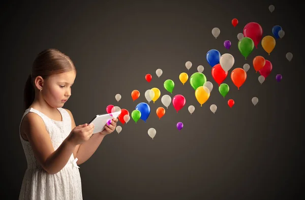 Cute Little Girl Using Tablet Colourful Balloons Concept — Stock Photo, Image