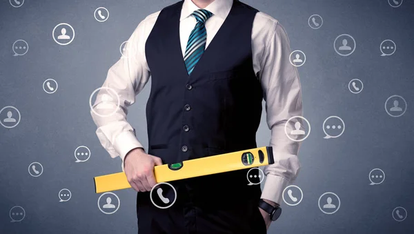 Handsome man standing with tool on his hand — Stock Photo, Image