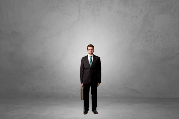 stock image Alone businessman standing in a dark room