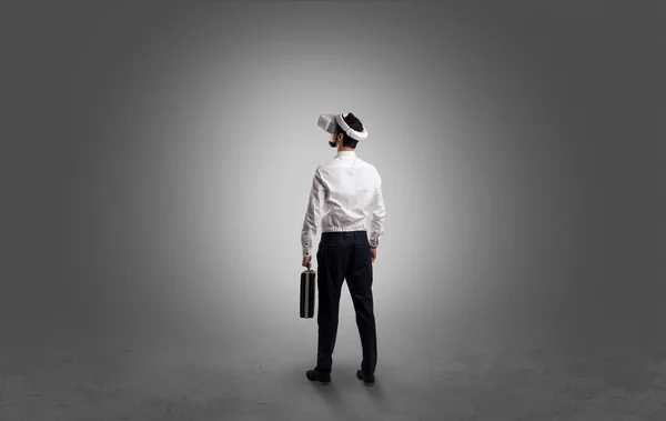 Businessman in an empty room with vr glasses