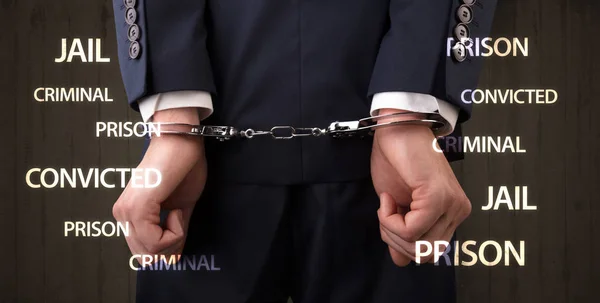 Close convicted with labels and handcuffs — Stock Photo, Image