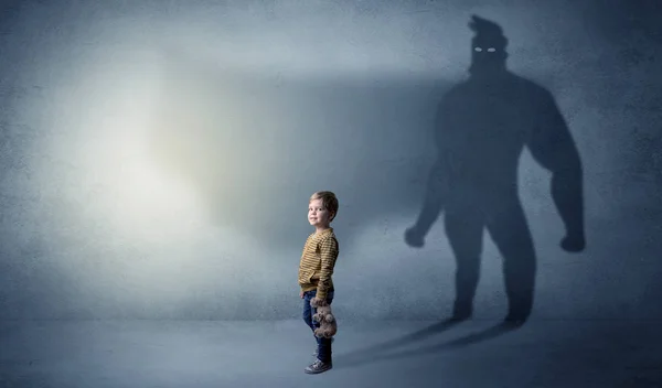 Cute kid with hero shadow behind — Stock Photo, Image