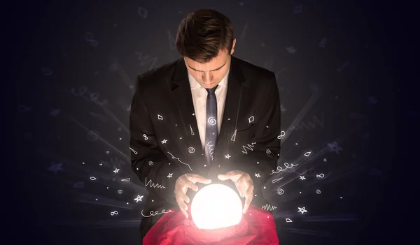 Businessman looking to inspiration in a magic ball and doodle concept — Stock Photo, Image