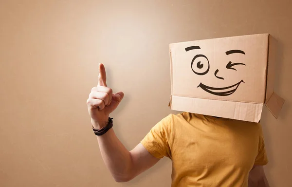 Young man  with happy cardboard box face — Stock Photo, Image