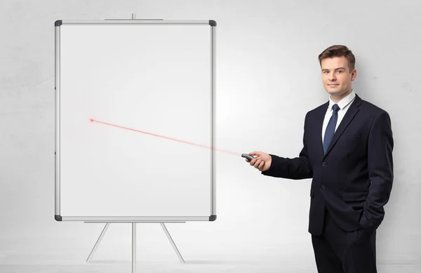 Businessman with laser pointer and copyspace white blackboard — Stock Photo, Image