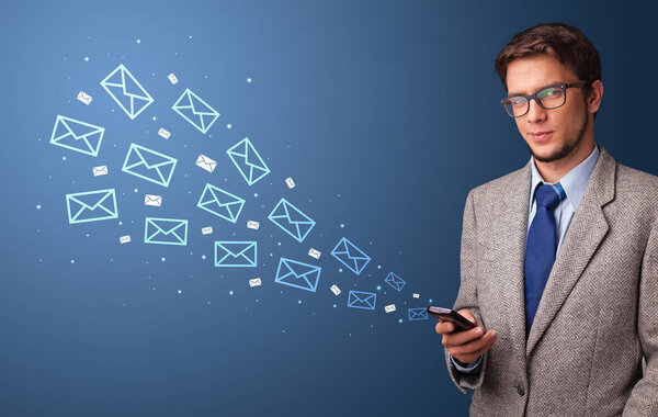 Businessman using phone with mail concept around