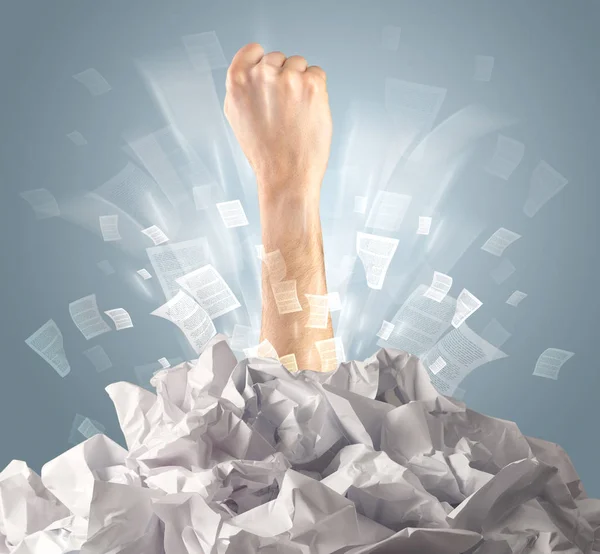 Hand coming out from paper pile — Stock Photo, Image