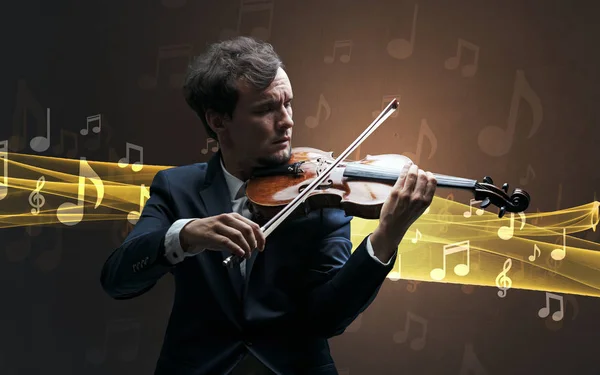 Musician playing on violin with notes around — Stock Photo, Image