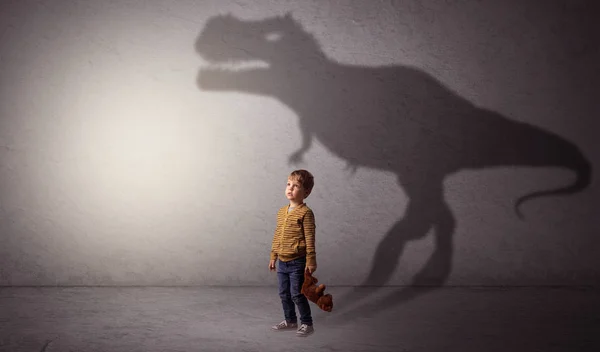 Dinosaurus shadow behind cute boy — Stock Photo, Image