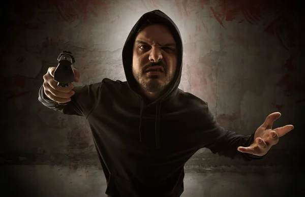 Armed assassin in an empty bloody room concept — Stock Photo, Image