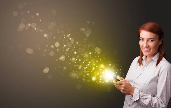 Using phone with gold sparkling concept — Stock Photo, Image