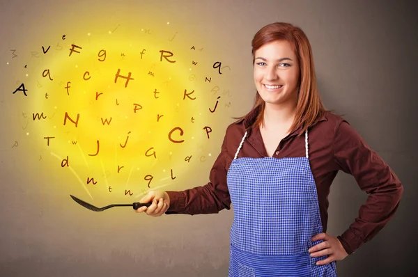 Person cooking letters in wok — Stock Photo, Image