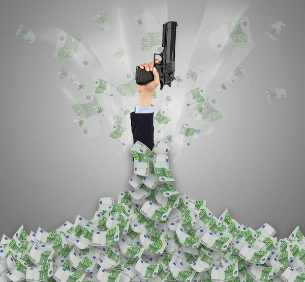 Hand buried in cash pile and trying to get out — Stock Photo, Image