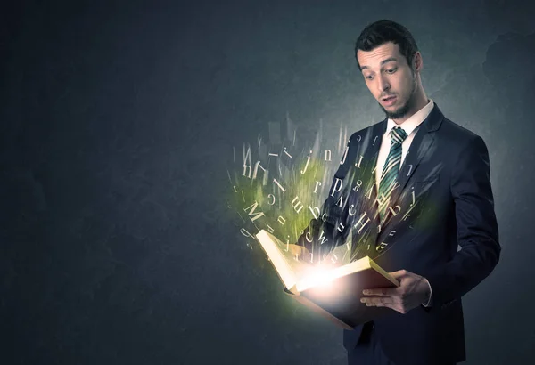 Businessman holding a book. — Stock Photo, Image