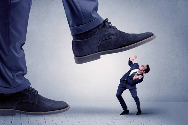 Young businessman getting crushed — Stock Photo, Image