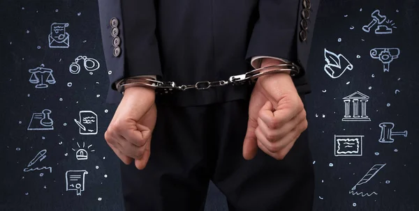 Symbols of courthouse with handcuffed man — Stock Photo, Image