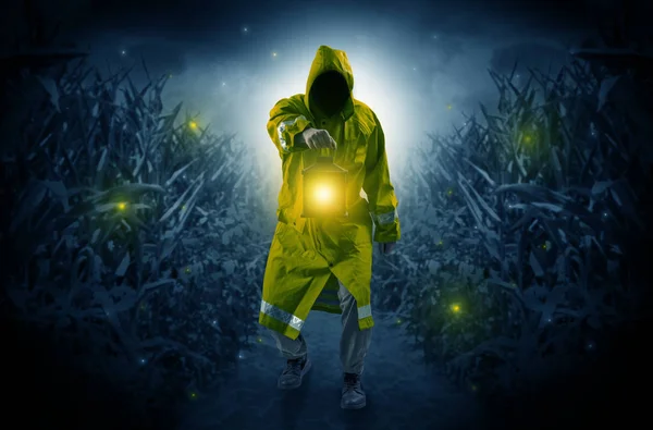 Man coming out from a thicket with lantern — Stock Photo, Image