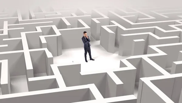 Businessman standing in a middle of a maze — Stock Photo, Image