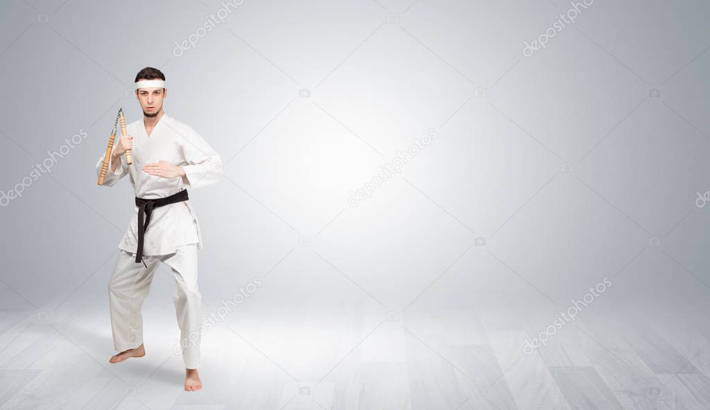 Karate trainer fighting in an empty space