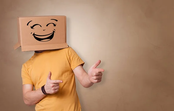 Young man  with cardboard box on his head — Stock Photo, Image