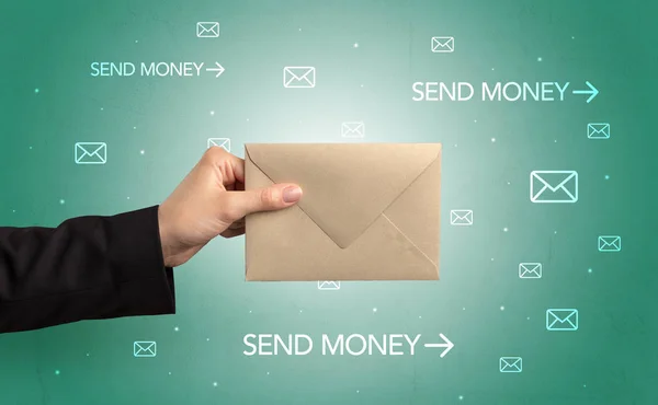 Hand holding envelope with symbols around — Stock Photo, Image