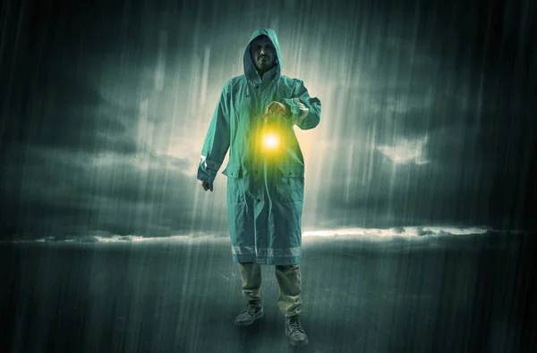 Man walking in storm with lantern — Stock Photo, Image