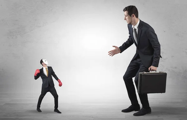 Businessman begging for small masked businessman — Stock Photo, Image