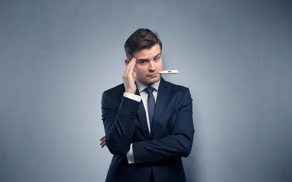Businessman with thermometer and copy space — Stock Photo, Image