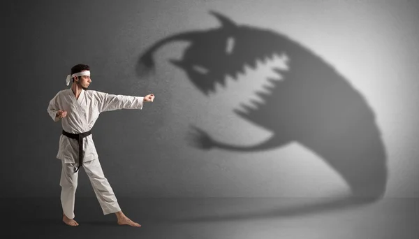 Karate man fighting with a big scary shadow — Stok Foto