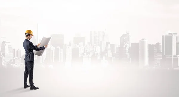 Architect standing and  looking at a big city panorama — Stock Photo, Image