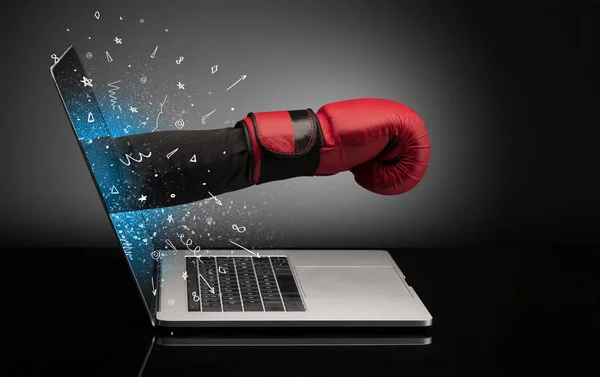 Hand with box gloves coming out of a laptop