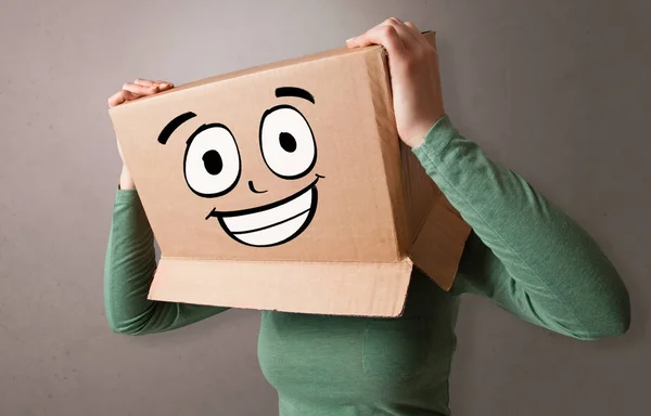 Young girl with happy cardboard box face — Stock Photo, Image