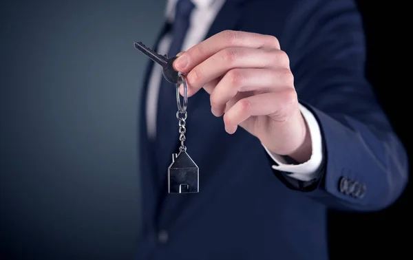 Young man hand over keys — Stock Photo, Image