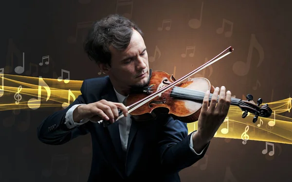 Musicien jouant du violon avec des notes autour — Photo
