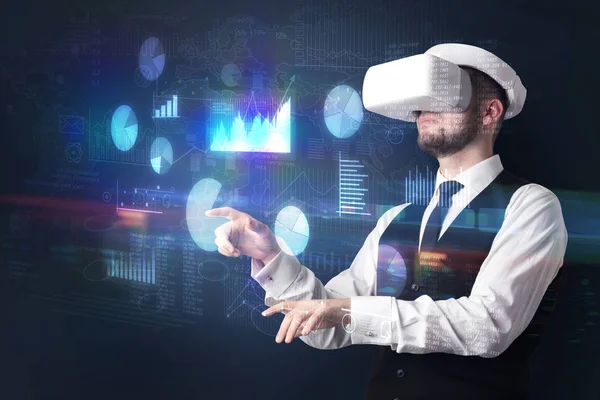 Man wearing VR goggles with charts and reports — Stock Photo, Image