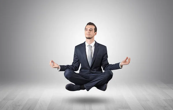 Businessman meditates in an empty space concept — Stock Photo, Image