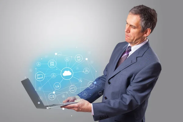 Man holding laptop with cloud based system concept — Stock Photo, Image